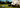 Golfer stood at the address of a golf ball with a golf putter